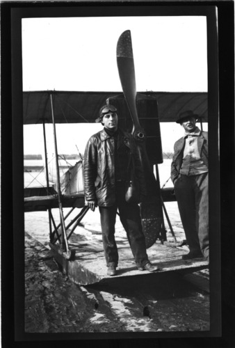 "First plane down Mississippi River. Janas, pilot, killed in Russia in 1917, stands in front of biwing airplane. Harris Hurlbert in sport jacket also in picture." Friars Point, Miss. Painter Collection. Call Number: PI/1988.0006 (MDAH)
